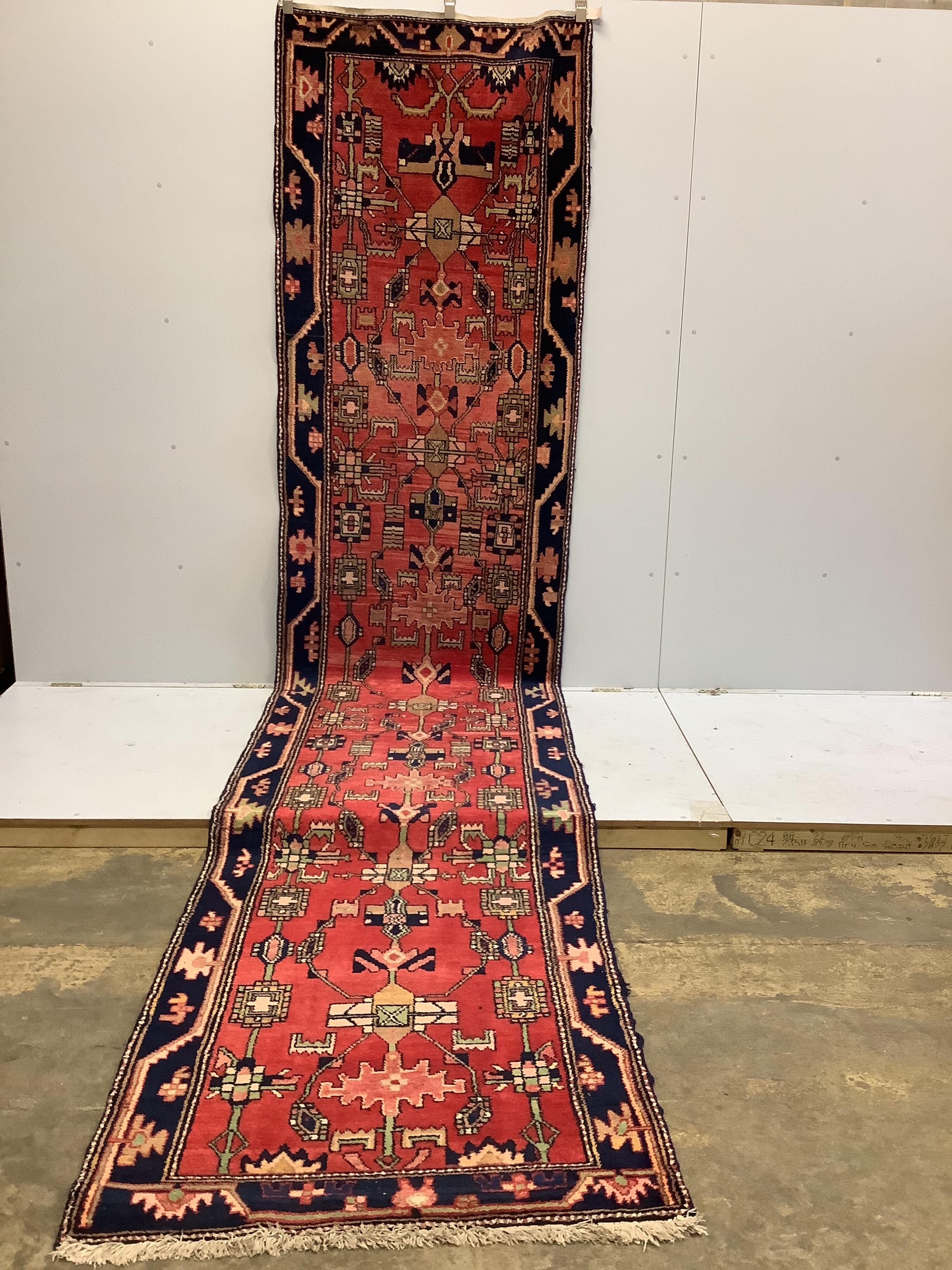 A Nahavand North West Persian red ground runner, 492cm x 110cm